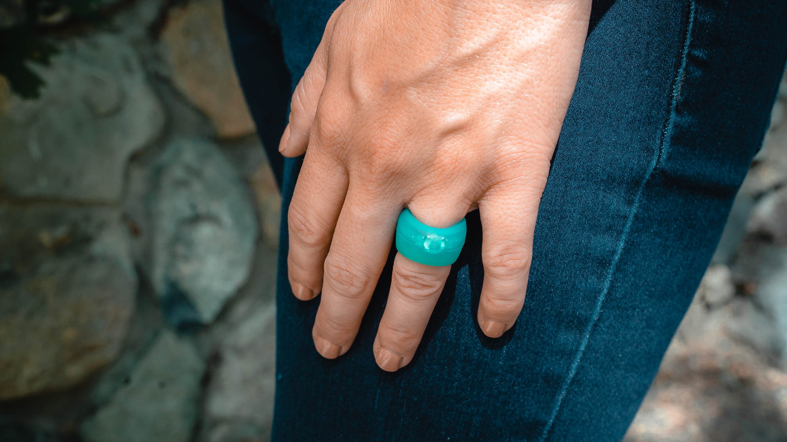 Teal Ring Wrapper silicone ring cover shown worn over a ring