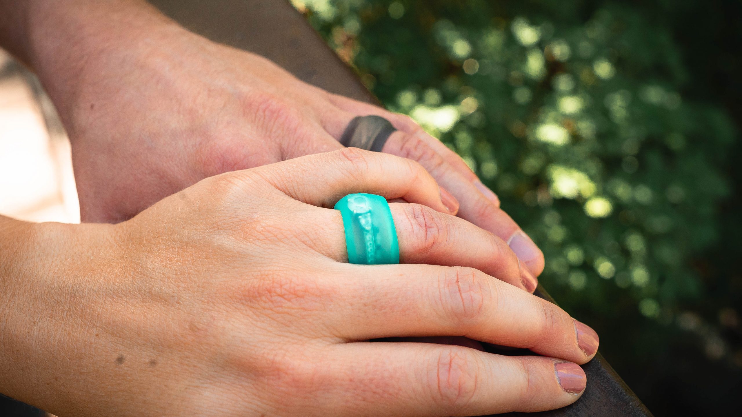 Teal Ring Wrapper silicone ring cover shown worn over a ring