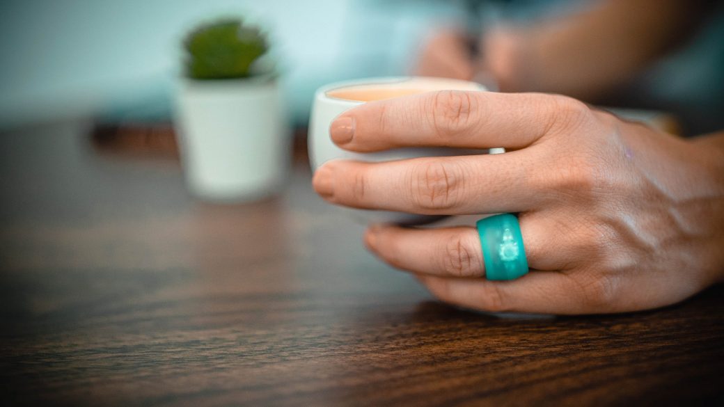 Teal Ring Wrapper silicone ring cover shown worn over a ring