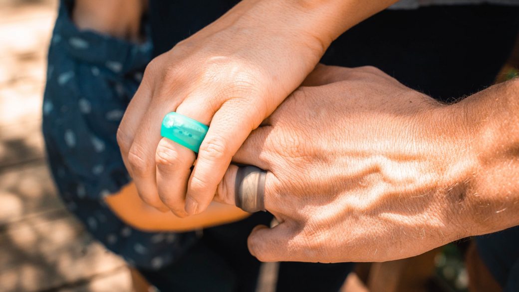 Teal Ring Wrapper silicone ring cover shown worn over a ring