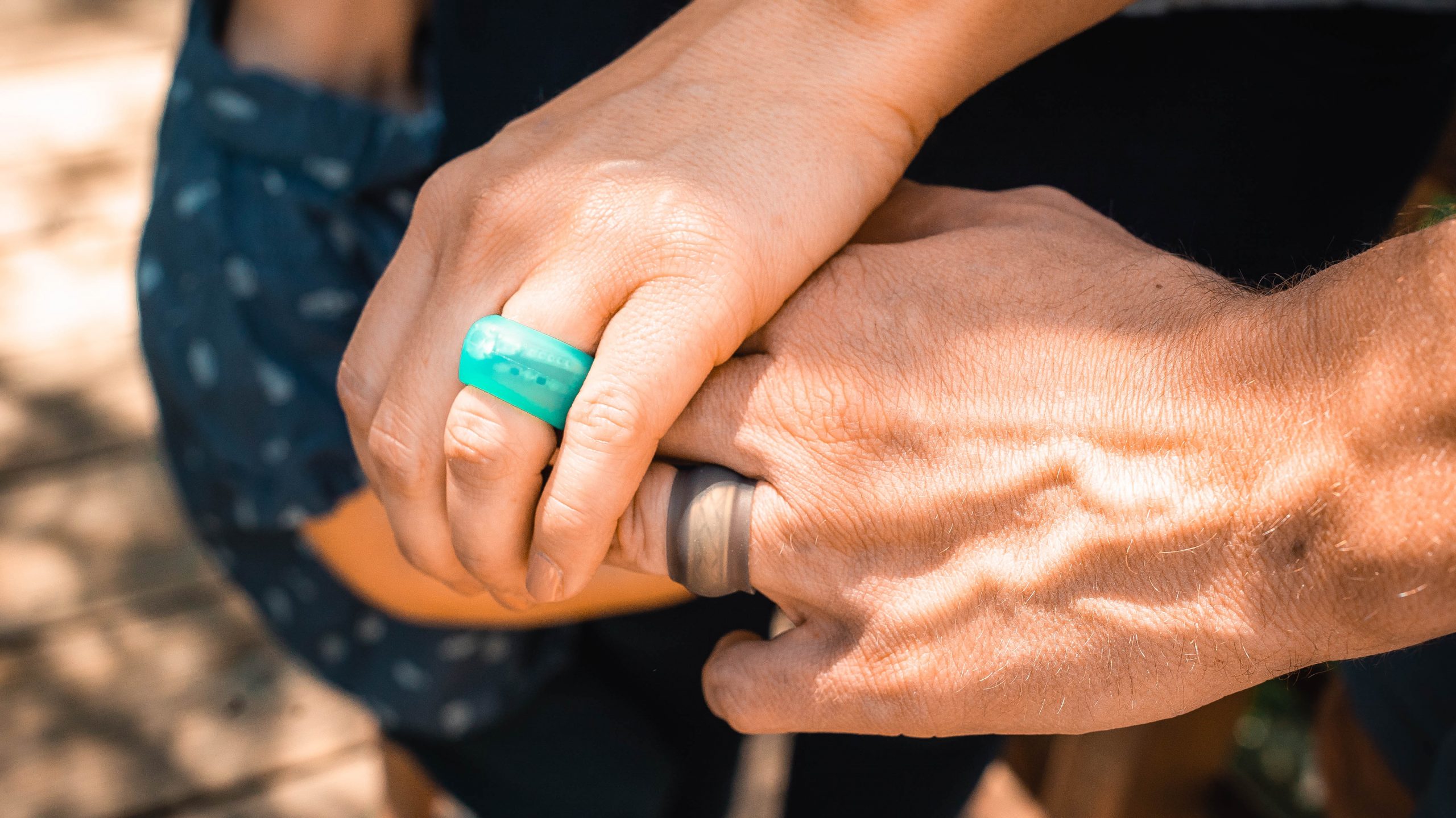 Black Ring Wrapper silicone ring cover shown worn over a ring