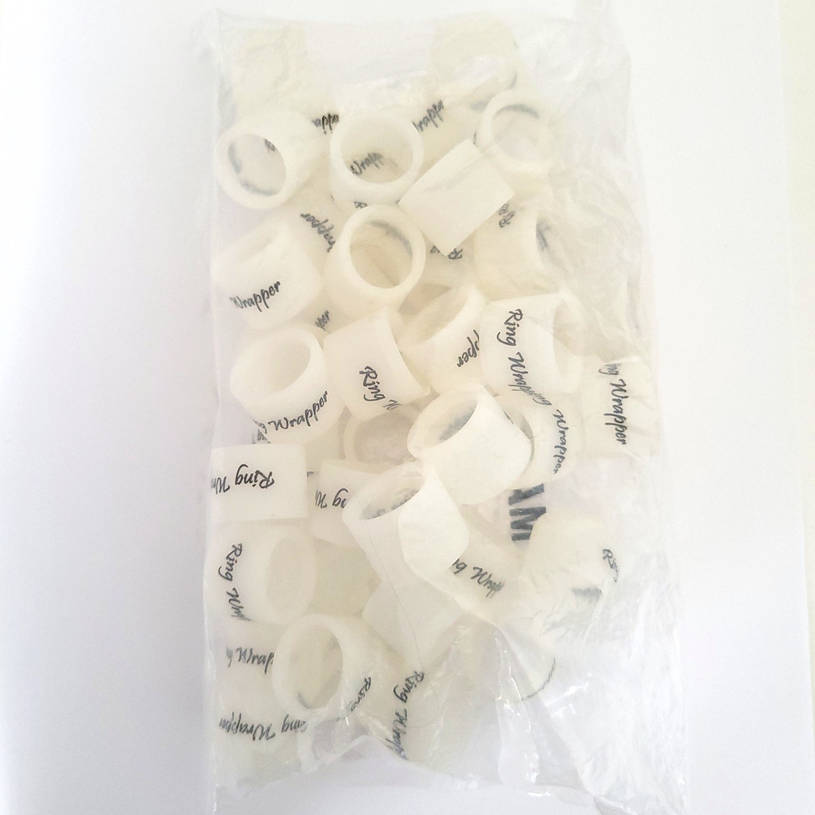 Fifty white Ring Wrapper Original silicone ring covers in a sealed bulk bag